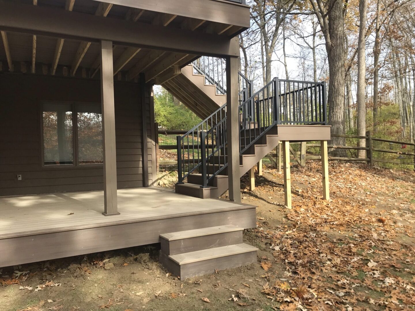 A deck with stairs and steps leading to the top of it.