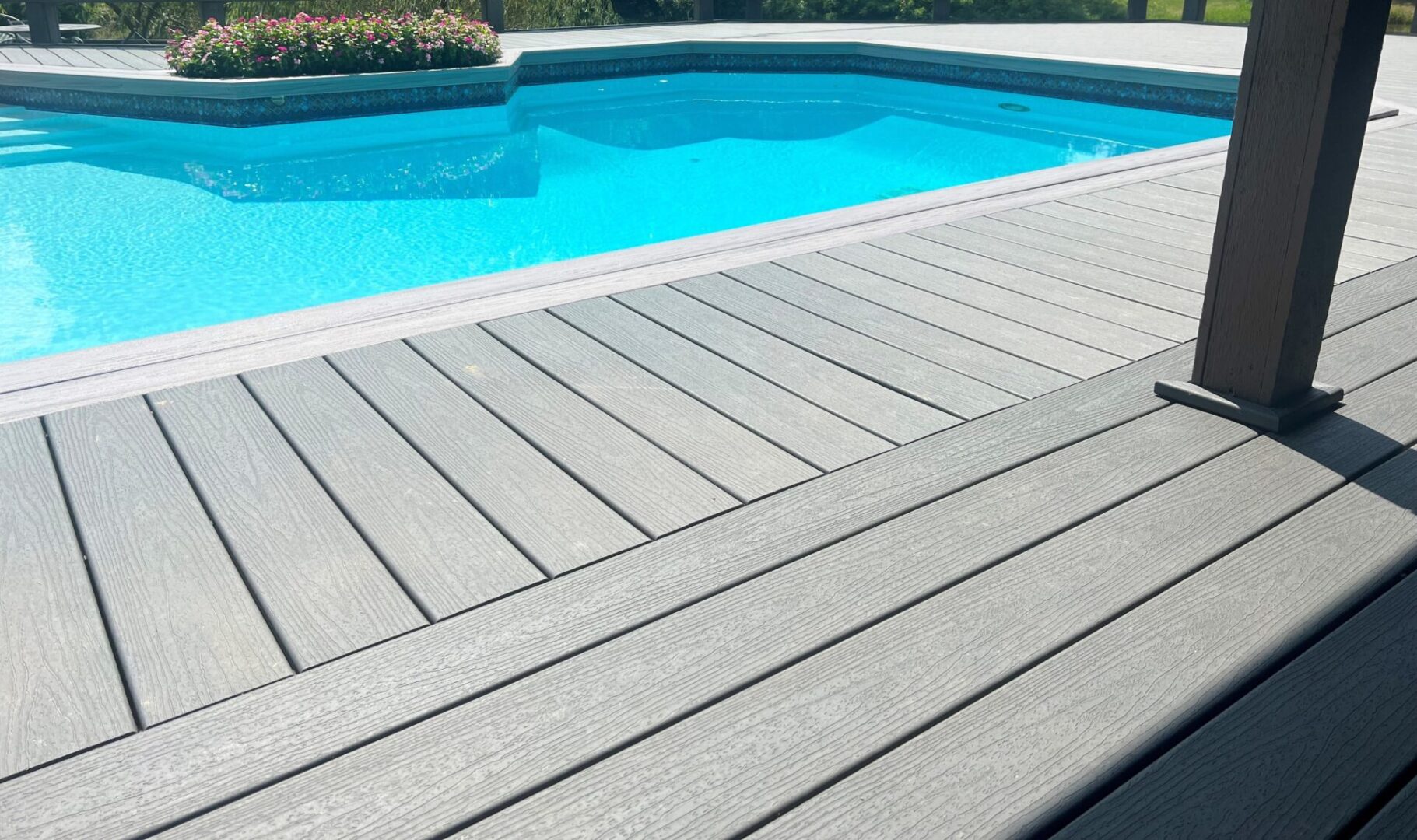A pool with a deck and steps in it