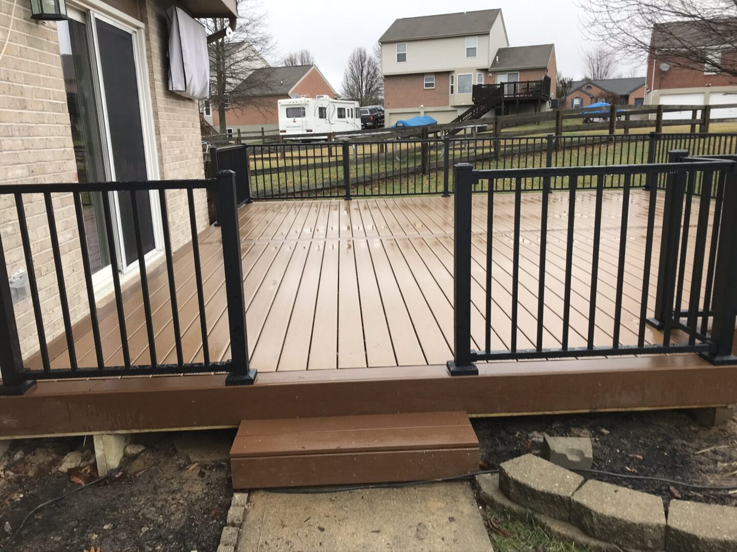 A deck with stairs leading to the back patio.