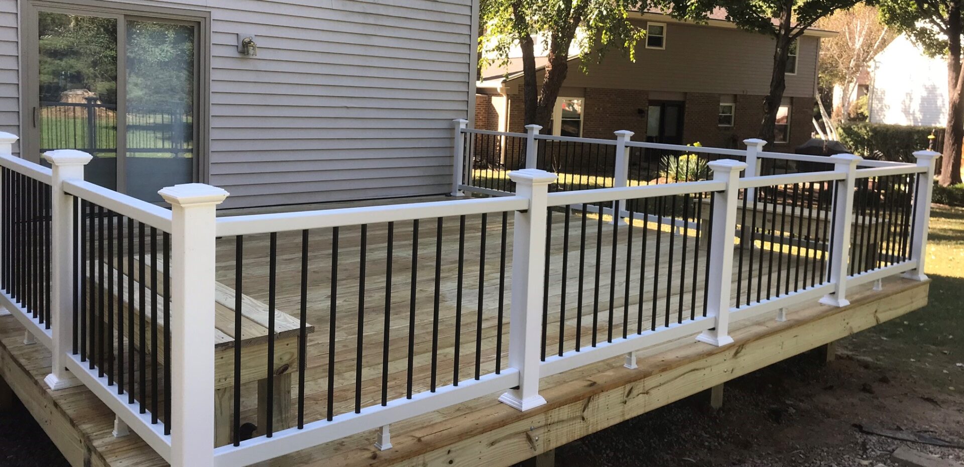 A deck with black and white railing on it